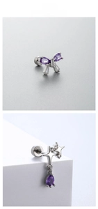 Detailed view of silver butterfly and star stud earrings with purple cubic zirconia