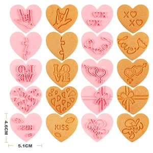 Set of 10 pink heart-shaped cookie cutters with LOVE and XOXO embossing patterns