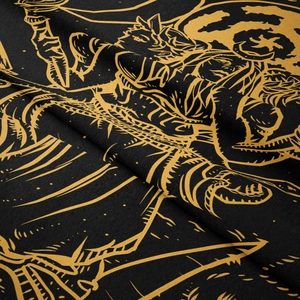 Detailed macro view of bohemian black and gold tapestry fabric with mystical tarot patterns