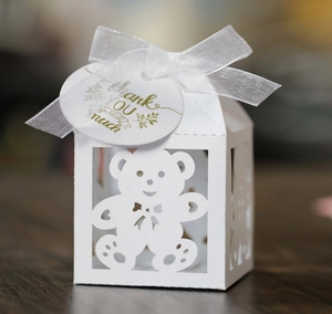 Detail of white hollow bear favor box with ribbon and gold Thank You gift tag