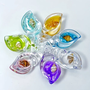 Macro detail of colorful glowing acrylic conch pendants with mini seashells inside