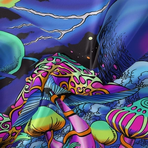 Detailed close-up of psychedelic mushroom print on soft bohemian wall tapestry fabric