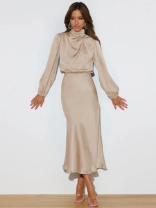 Detail of elegant champagne satin dress featuring a high draped neck and lantern sleeves