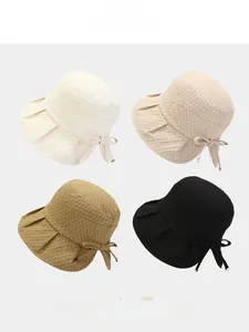 Detail of four colorful bow sun hats showing unique bubble fabric texture and elegant design