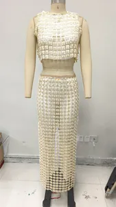 Detail of bohemian ivory crochet mesh two-piece set with floral appliques on mannequin