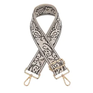 Close-up of ethnic paisley jacquard bag strap with gold metal swivel snap hooks