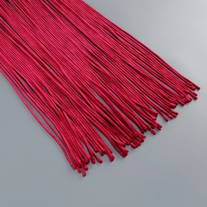 Close-up of elegant rose red velvet dress fabric with dense fringe tassel detailing