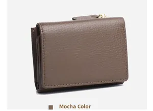 Detailed macro view of mocha lychee pattern leather and metal zipper on the tri-fold wallet