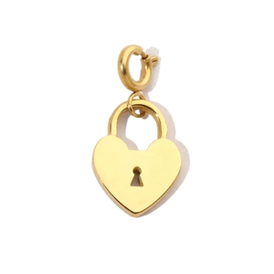 Detail of a golden heart-shaped lock pendant with a keyhole design on white background