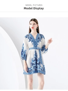 Detail of the V-neckline and vintage bohemian print on a blue and white mini dress