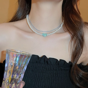 Double-layered choker necklace with blue beads, pearls and a light blue heart pendant