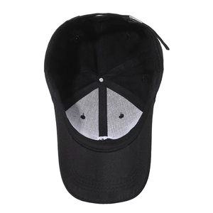 Internal view of black cotton baseball cap showing white mesh lining and silver metal buckle