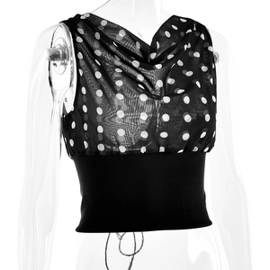 Close-up of sheer black polka dot chiffon top with elastic waist detail and mesh fabric
