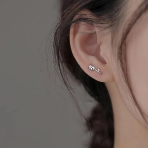 Minimalist silver tulip flower stud earrings worn by model with elegant metallic texture