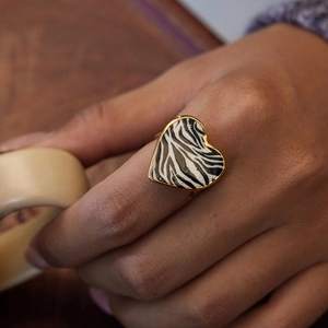 18K gold plated stainless steel heart ring with zebra print enamel on wooden background