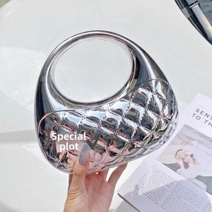 Silver metallic moon clutch bag with diamond quilted pattern and circular handle