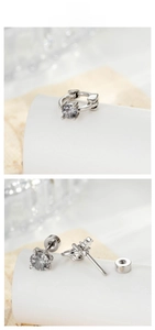 Detail view of silver screw-back stud earrings and hoop with round zircon stones