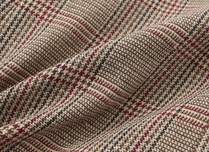 Close-up detail of premium houndstooth fabric in brown beige and dark red textile weave