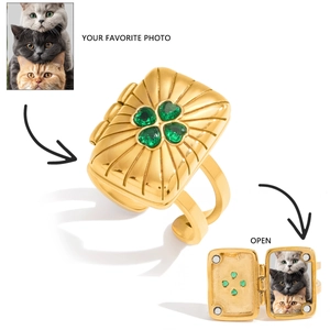 Detail showing the openable square locket ring with clover green stone and photo space