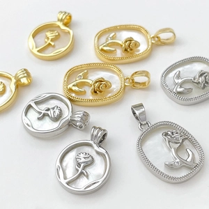 Macro view of 18k gold plated rose pendants with white mother of pearl inlay detail