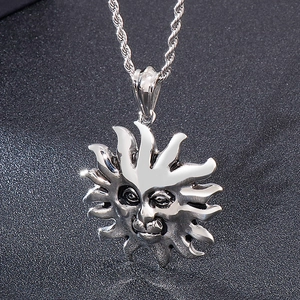 Detailed view of silver sun god face pendant with twisted rope chain on dark background