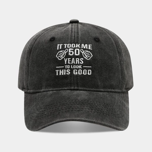 Detail of 50th birthday embroidery on washed cotton charcoal grey baseball cap