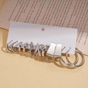 Detailed set of silver geometric hoop earrings including C-shaped and round metal designs