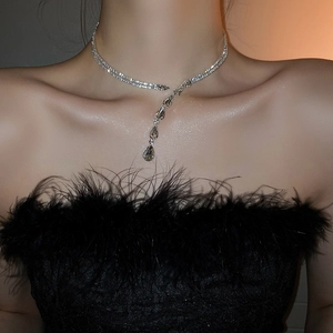 Close-up of double layer silver snake chain necklace with zircon teardrop pendant on model
