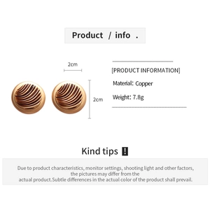 Detailed close-up of retro geometric round earrings with swirl texture and brown enamel