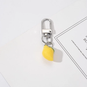 Realistic resin lemon keychain charm with texture and silver metal carabiner detail