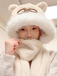 Detail of plush teddy bear ears on a soft cream fleece hooded scarf for women