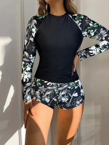Women's two-piece long sleeve sun protection swimsuit with tropical floral print in black
