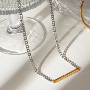 Two-tone stainless steel chain necklace featuring a gold cylindrical pendant for women