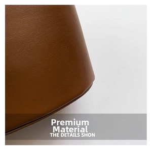 Macro shot of premium brown lychee-textured leather on a vintage-style bucket bag