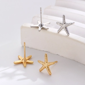 Macro detail of starfish ear cuffs in gold and silver finish with realistic texture