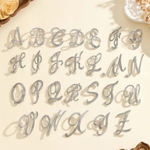 Elegant silver A-Z alphabet brooches set with sparkling rhinestones in cursive script