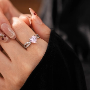 Elegant pink heart-shaped zircon ring with shimmering pavé diamonds on a silver band