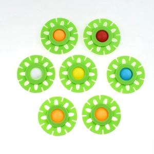 Top view of seven colorful silicone flower-shaped fidget toys on a white background