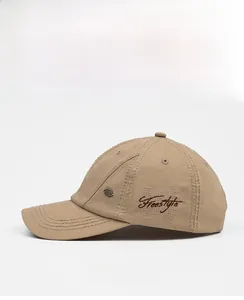 Detail of khaki washed cotton baseball cap with Freestyle embroidery and metal plate