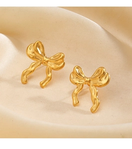 Macro shot of 18K gold bow-knot earrings featuring elegant metallic pleated texture