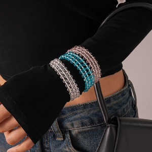 Close-up of multi-layered beaded bracelet with blue, pink and clear glass crystals