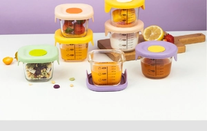 Detailed view of glass baby food jars with colorful lids and clear volume scale markers
