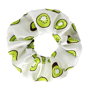 Macro detail of high-quality fabric scrunchie with vivid green kiwi fruit pattern prints