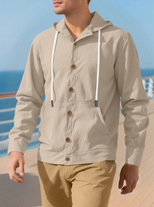 Linen button-down hooded jacket for men in beige shown on a scenic cruise deck outdoor
