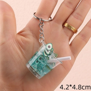 Detail shot of mini avocado drink keychain showing realistic slices and dimensions