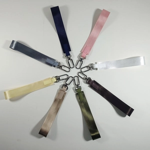 Cinturini da polso in nylon multicolore con clip in metallo su sfondo bianco lucido