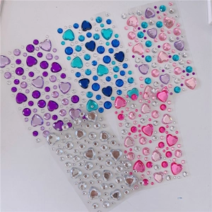 Close-up of four sheets of self-adhesive 3D heart and round crystal rhinestones