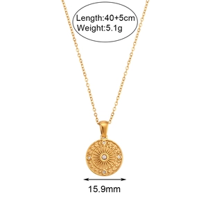 Gold compass pendant necklace with white zircons and sunburst texture on white background