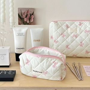 Quilted white bow print cosmetic bag set including a rectangular and triangle pouch