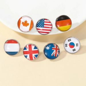Macro shot of assorted round glass cabochon lapel pins featuring various national flag designs